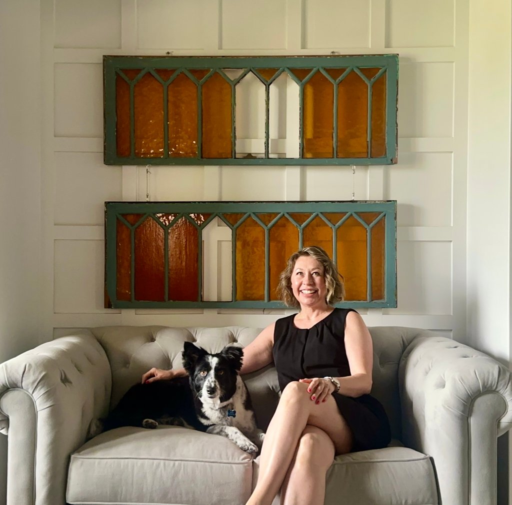 Border collie dog and beautiful woman sitting on a couch